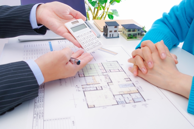 電卓で金額を提示している営業マン